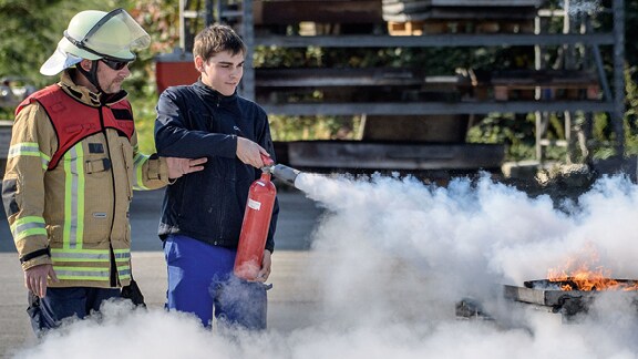 Boy using Fire extinguisher