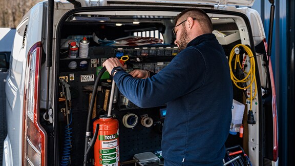 man checking fire extinguisher