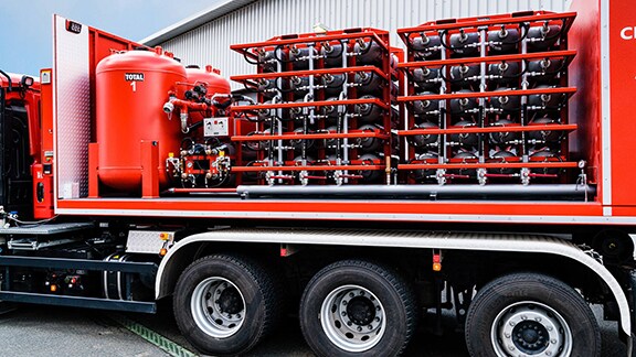 A truck carrying rows of fire extinguishers