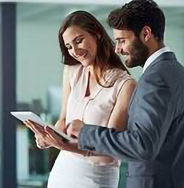 Two employees looking at the tab and discussing