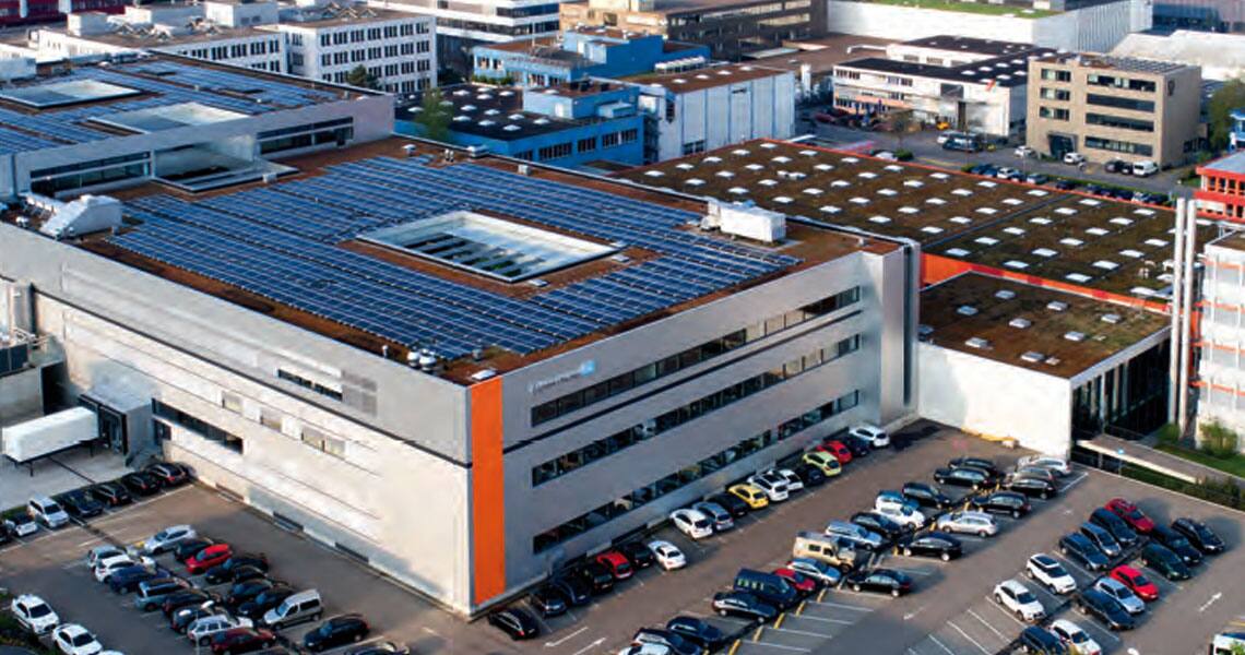 Cars parked outside a factory
