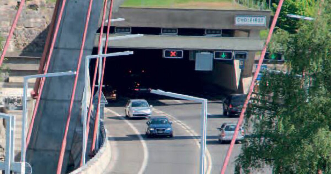 A fleet of cars passing through a tunnel