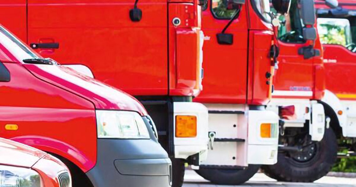 Group of fire trucks parked in a parallel line