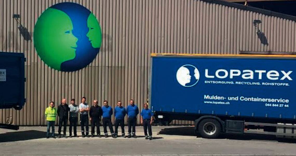 Group of firefighters in uniform standing outside a Lopatex office