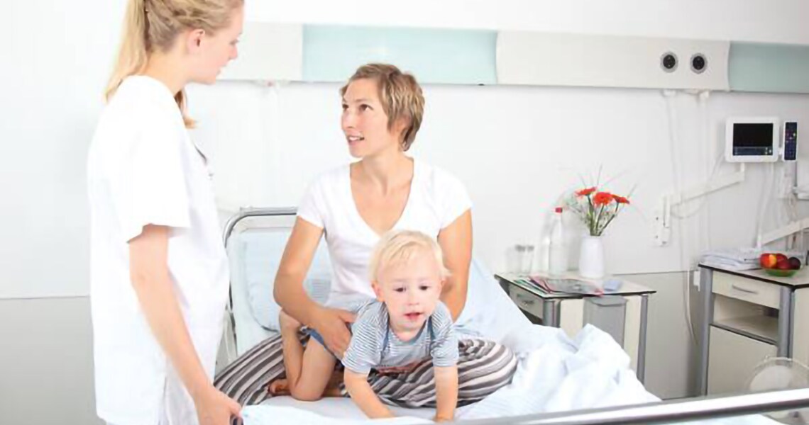 Healthcare worker speaking to a mother in hospital