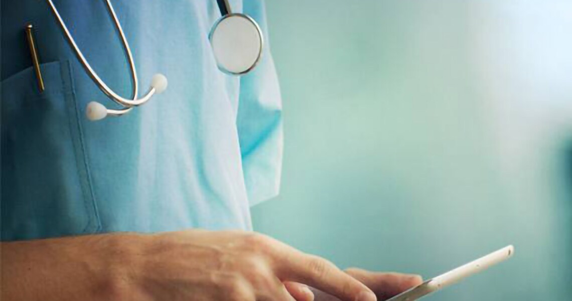Close-up of a healthcare worker using a tablet