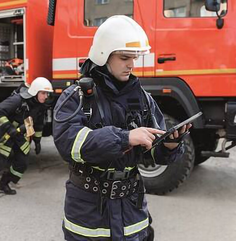 Firefighters at a scene unpacking gear from the firetruck and running