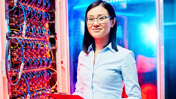 Lady technician working on board with wires