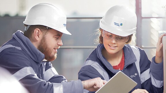 Two technicians looking at the tab