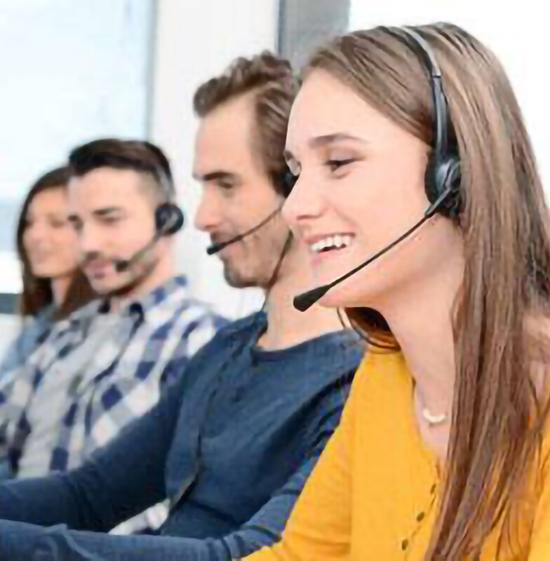 Group of service hotline employees working while wearing a headset