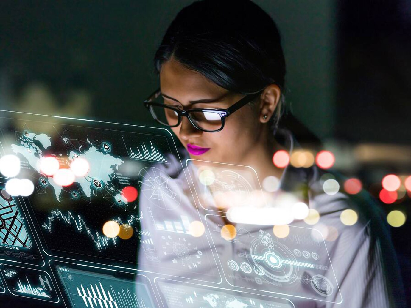 A woman working on a smart screen displaying different tabs
