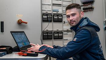 Man smiles and working on Laptop